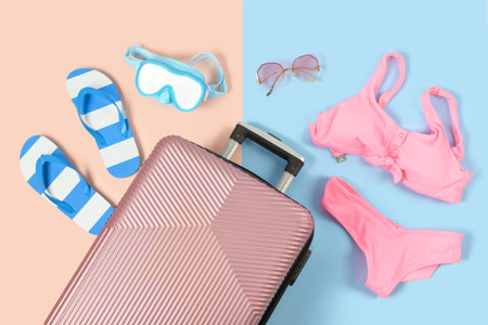 Composition with suitcase and beach accessories on color backgroundの写真素材