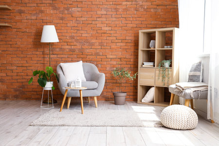 Stylish gray armchair and coffee table in interior of living roomの写真素材