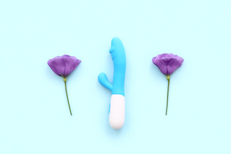 Beautiful eustoma flowers and vibrator on blue backgroundの写真素材