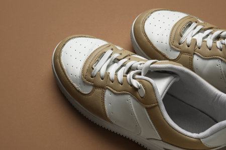 Stylish sneakers on brown backgroundの写真素材