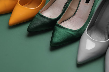 Different stylish high heels on green backgroundの写真素材