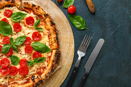 Wooden board with tasty pizza Margarita on black backgroundの写真素材