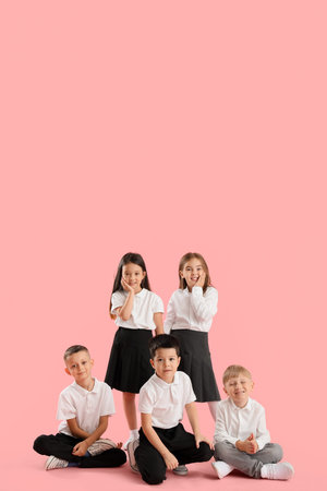 Little school children on pink background