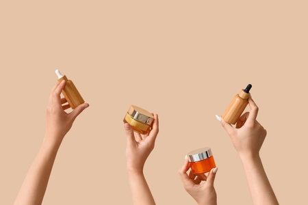 Women with cosmetic products on beige backgroundの写真素材