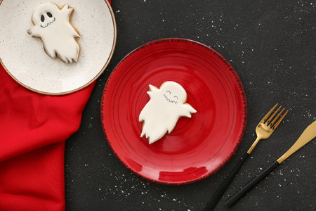 Halloween table setting with tasty cookies on dark background, closeupの写真素材
