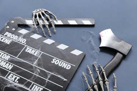 Clapperboard with Halloween decor on blue backgroundの写真素材