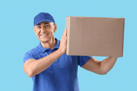 Mature courier with parcel on blue background