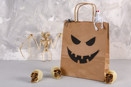 Shopping bag with decorations for Halloween on gray backgroundの写真素材