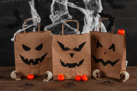 Shopping bags with decorations for Halloween on tableの写真素材