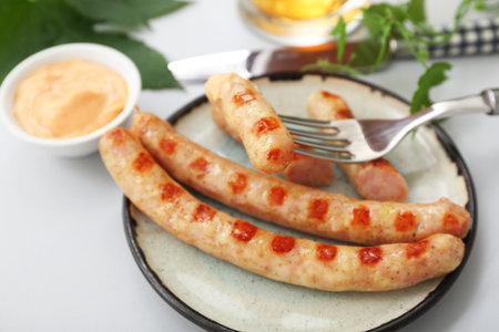 Plate with tasty Bavarian sausages on gray backgroundの写真素材
