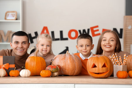 Happy family with Halloween pumpkins in kitchenの写真素材