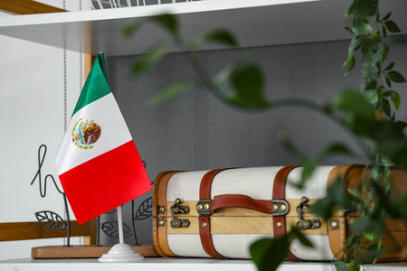 Mexican flag with suitcase on shelf in roomの写真素材