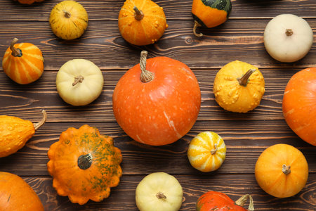 Different fresh pumpkins on wooden backgroundの写真素材