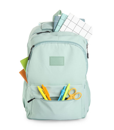 Stylish blue school backpack with different stationery supplies on white backgroundの写真素材