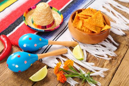 Poncho with food and Mexican symbols for Independence Day on wooden background, closeupの写真素材