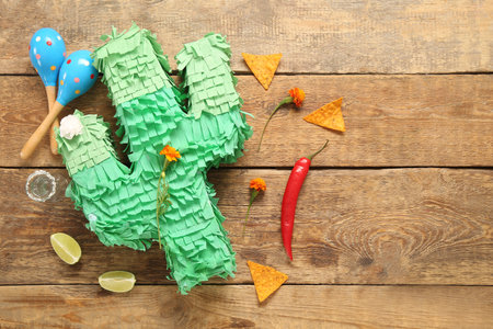 Composition with Mexican pinata, food and tequila shot for Independence Day on wooden backgroundの写真素材