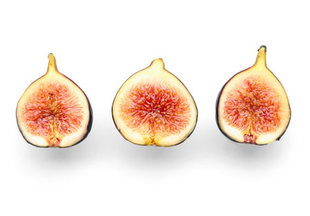 Halves of fresh ripe figs on white backgroundの写真素材