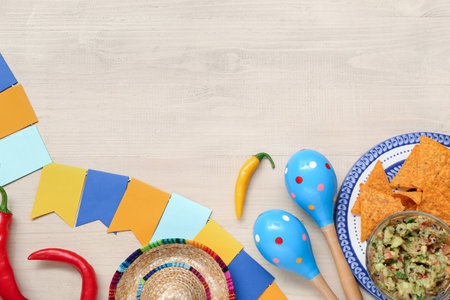 Sombrero, maracas, nachos and garland on wooden background. Mexico's Independence Day celebrationの写真素材