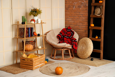 Interior of living room with Halloween pumpkins, shelf unit and armchairの写真素材