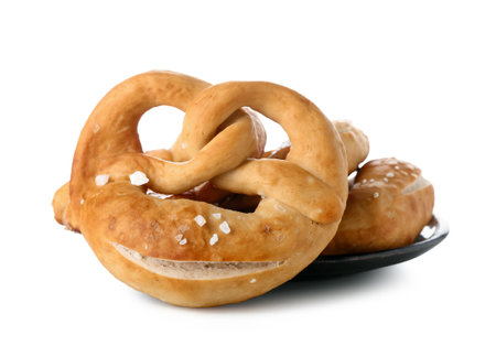 Plate with tasty pretzels on white backgroundの写真素材