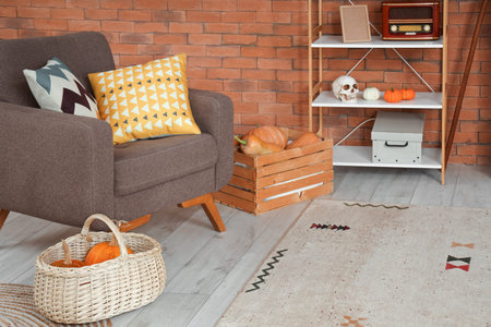 Interior of living room with armchair, shelf unit and Halloween pumpkinsの写真素材
