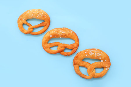 Soft pretzels on blue background