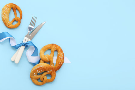 Soft pretzels and ribbons in color of Bavarian flag on blue backgroundの写真素材
