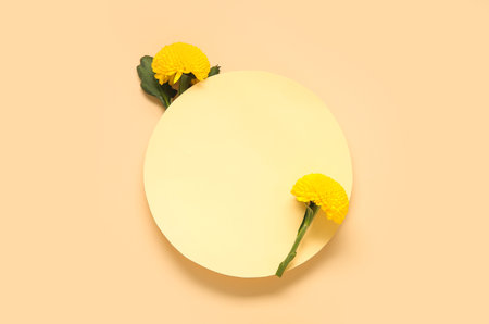 Composition with blank paper sheet and beautiful chrysanthemum flowers on beige backgroundの写真素材
