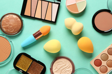 Composition with different cosmetic products and makeup sponges on color backgroundの写真素材
