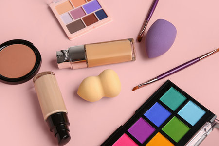 Composition with different cosmetic products and makeup accessories on pink backgroundの写真素材