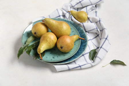 Plates with ripe pears on white backgroundの写真素材