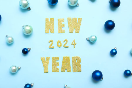 Text NEW 2024 YEAR with different Christmas balls on blue background