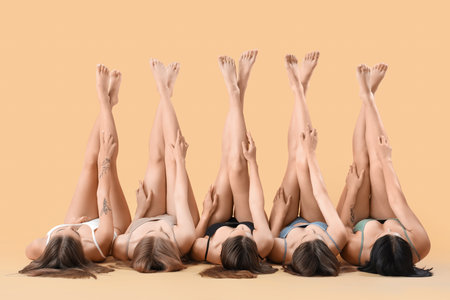 Many beautiful women in underwear on beige backgroundの写真素材
