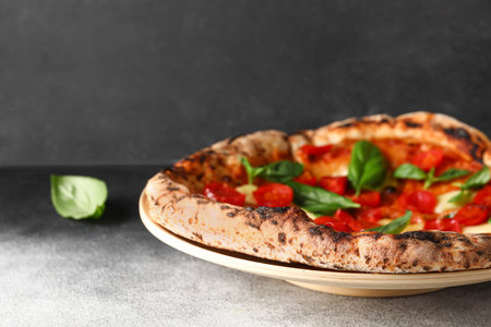 Plate with tasty pizza Margarita on tableの写真素材