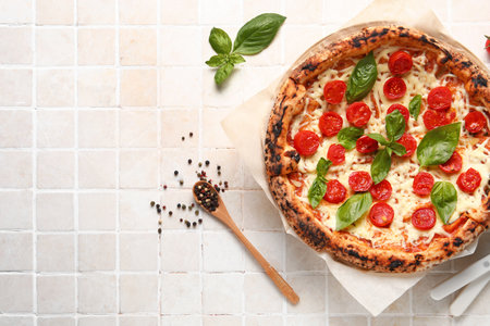 Tasty pizza Margarita on beige tile backgroundの写真素材