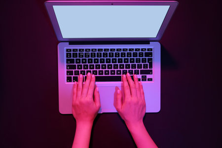 Woman working with modern laptop on black backgroundの写真素材