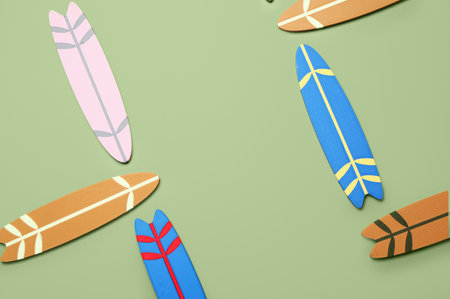Different mini surfboards on green backgroundの写真素材