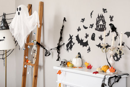 Mantelpiece with pumpkins, fallen leaves, candles and Halloween decor in living roomの写真素材