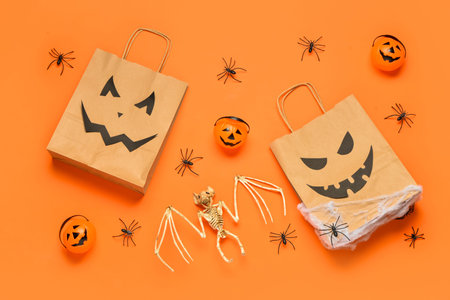 Composition with shopping bags and Halloween decorations on color backgroundの写真素材