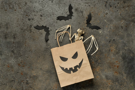 Composition with shopping bag and Halloween decorations on grunge backgroundの写真素材