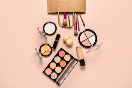 Shopping bag with makeup cosmetics on beige backgroundの写真素材