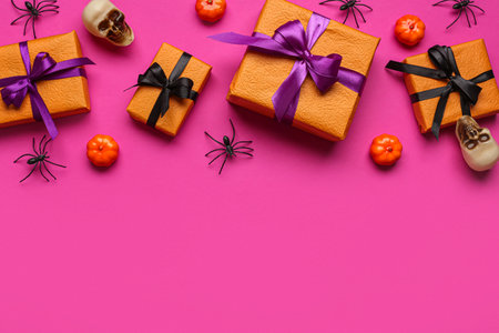 Composition with different gifts and Halloween decorations on pink backgroundの写真素材