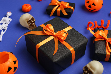 Composition with gift boxes and Halloween decorations on blue background, closeupの写真素材