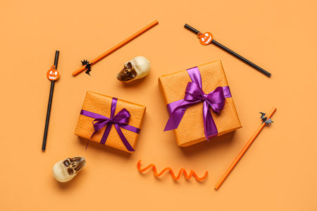 Composition with gift boxes, drinking straws and Halloween decorations on color backgroundの写真素材