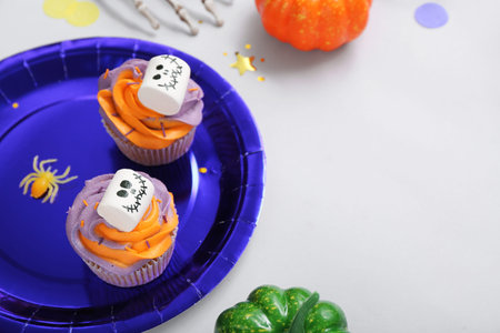 Halloween cupcakes decorated with spooky marshmallows on gray table, closeupの写真素材