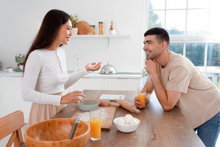 Happy young couple cooking in the kitchenの写真素材
