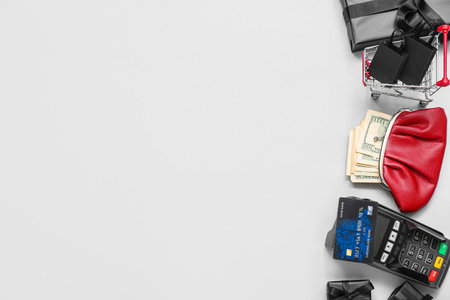 Wallet with money, payment terminal and shopping cart on white background. Black Friday conceptの写真素材