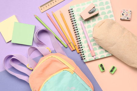 Stylish school backpack with different stationery supplies on colorful background