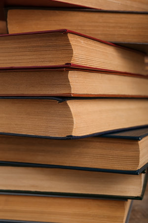 Stack of old hardcover books on wooden background, closeupの写真素材