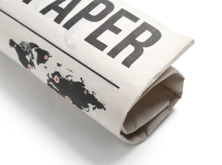 Rolled newspaper isolated on white background, closeupの写真素材